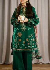green embroidered traditional outfit with a plain background